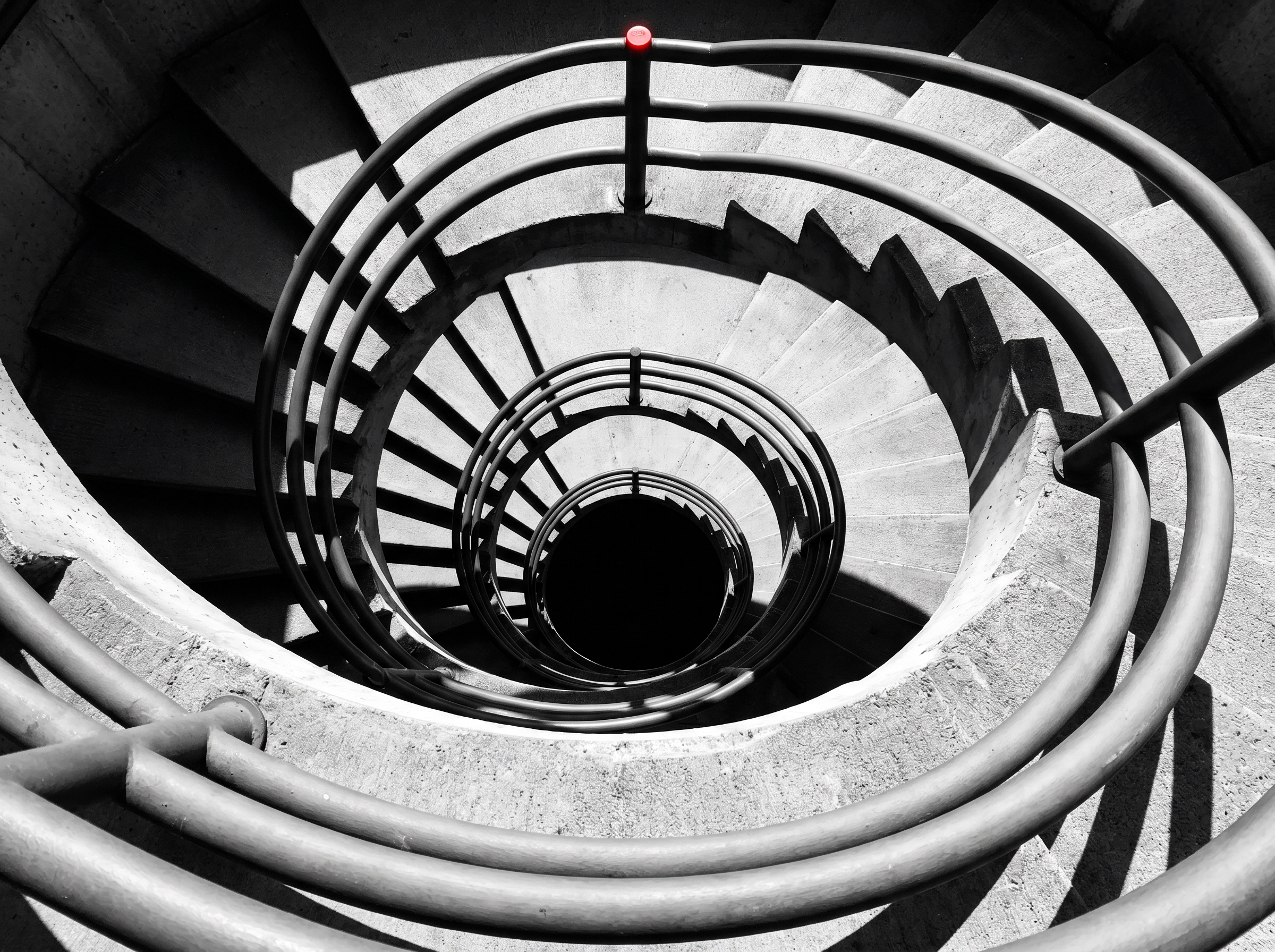 Spiral brutalist stairwell — different paths, same descent