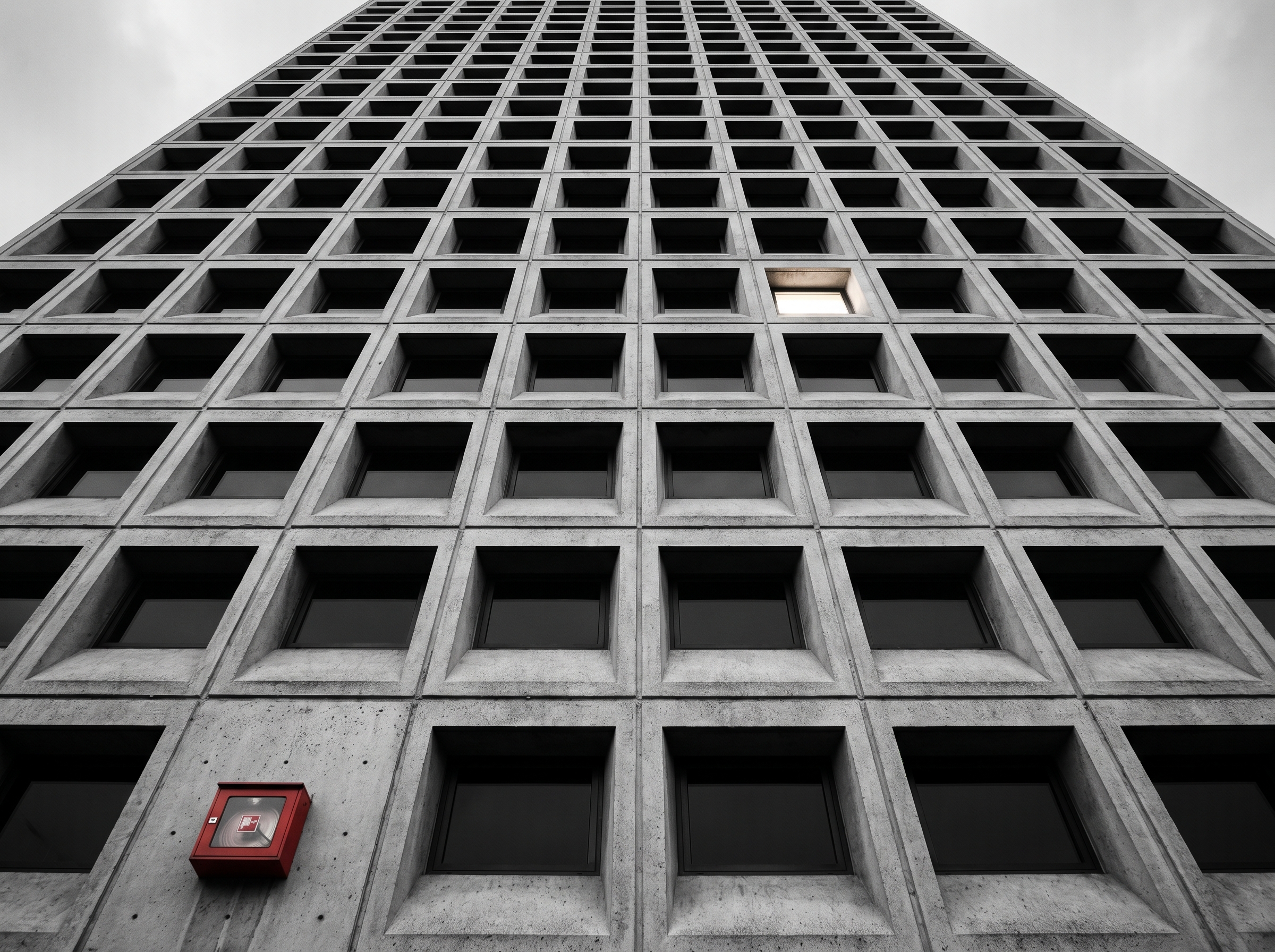 Brutalist tower facade with repeating window grid — rhythm of systems